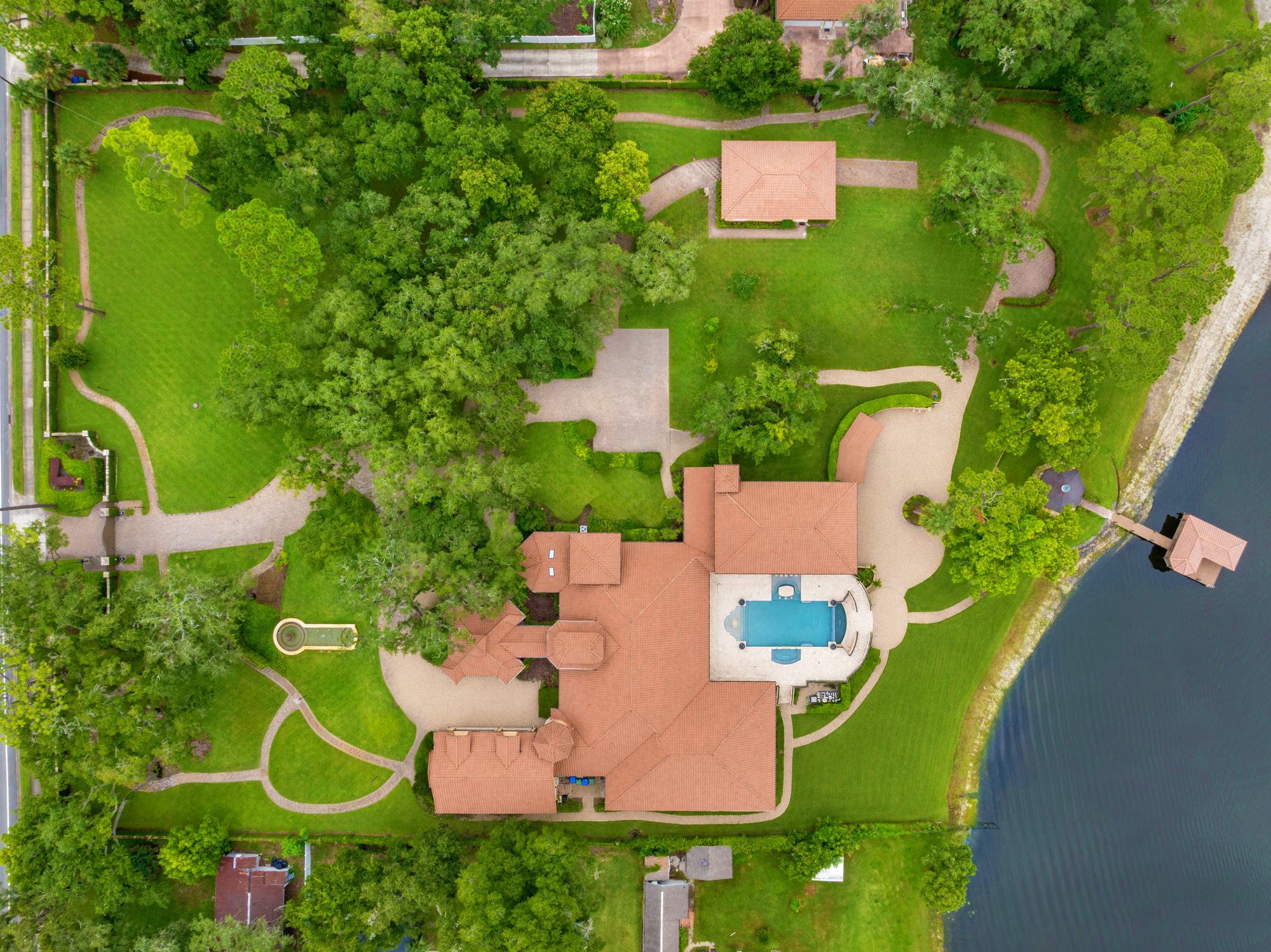 Aerial view of the estate, pool, and private dock on Lake Mary